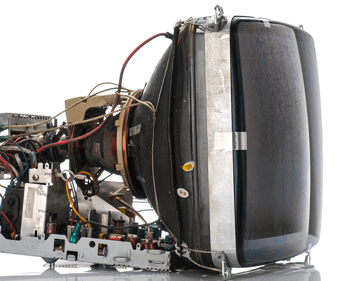 A photo of an old tube tv but with the outside casing removed, exposing all the insides and connections to the tube and various parts.