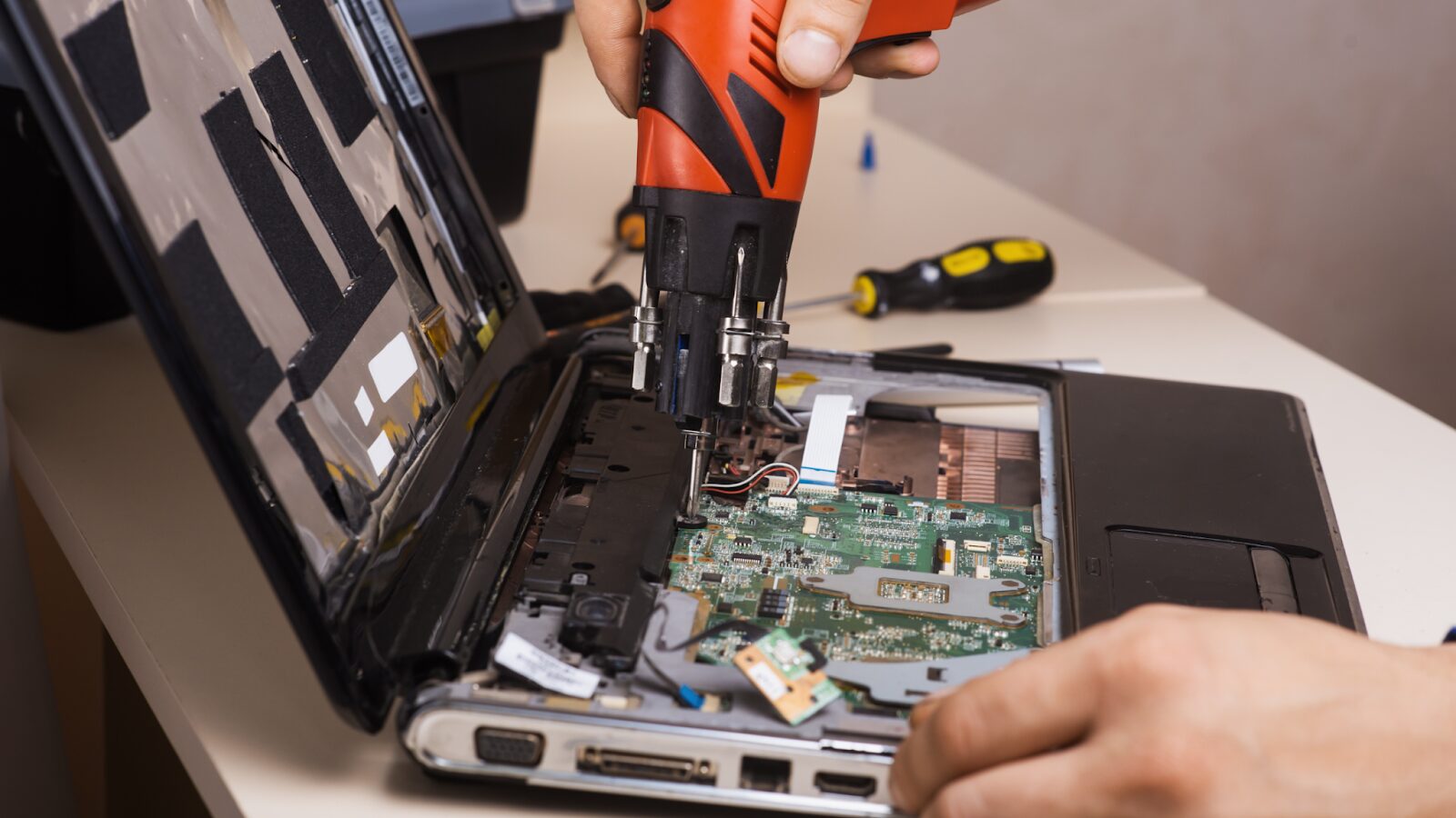 Professional technician processing electronic waste